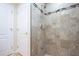 Shower featuring neutral tile walls, a shower caddy and tiled floor at 2675 Firestone Dr, Clearwater, FL 33761