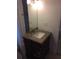 Bathroom vanity with granite countertop, dark wood cabinet, and decorative mirror at 3115 Winchester Dr, Dunedin, FL 34698