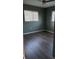 Bedroom with neutral walls, hardwood floors, and natural light from windows at 3115 Winchester Dr, Dunedin, FL 34698