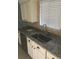 Modern kitchen sink with granite countertops and stainless steel fixtures at 3115 Winchester Dr, Dunedin, FL 34698