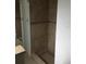 Modern shower featuring glass doors, stone floors, and stone tiling at 3115 Winchester Dr, Dunedin, FL 34698