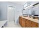 Bright bathroom with a marble countertop vanity, framed mirror, and a separate room containing the shower at 3130 Walnut Ne St, St Petersburg, FL 33704