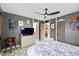 Comfortable bedroom featuring tiled flooring, an overhead fan, and bright decor at 3130 Walnut Ne St, St Petersburg, FL 33704