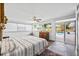 Well-lit bedroom with tiled floors, a ceiling fan, and sliding glass doors that open to the pool area at 3130 Walnut Ne St, St Petersburg, FL 33704