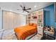 Comfortable bedroom featuring built in wardrobe and shelving, and bright orange bedding at 3130 Walnut Ne St, St Petersburg, FL 33704