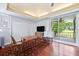 Bedroom with wood floors, adjacent closet, table and chairs, and a sliding glass door to the covered balcony at 3130 Walnut Ne St, St Petersburg, FL 33704