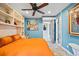 Comfortable bedroom featuring built-in shelving, orange bedding, and neutral walls at 3130 Walnut Ne St, St Petersburg, FL 33704