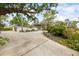 View of the home showcasing the mature landscaping and long private driveway at 3130 Walnut Ne St, St Petersburg, FL 33704