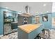 Modern kitchen with a dual-surface island, stainless steel appliances, sleek cabinets, and geometric patterned flooring at 3130 Walnut Ne St, St Petersburg, FL 33704
