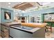 Modern kitchen island featuring an induction cooktop with sleek gray cabinets and wood accents at 3130 Walnut Ne St, St Petersburg, FL 33704