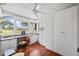 Bright office featuring a built-in desk, hardwood floors, large windows and built in storage cabinets at 3130 Walnut Ne St, St Petersburg, FL 33704