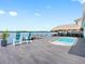 Stunning backyard with a private pool, tiki bar, and dock overlooking the water at 326 176Th Avenue Cir, Redington Shores, FL 33708