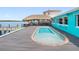Backyard pool and dock with a tiki bar and lounge area for outdoor entertaining at 326 176Th Avenue Cir, Redington Shores, FL 33708