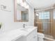 Updated bathroom featuring a glass shower, modern vanity, and sleek fixtures at 326 176Th Avenue Cir, Redington Shores, FL 33708