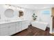Bathroom with double vanity, soaking tub, and modern fixtures at 326 176Th Avenue Cir, Redington Shores, FL 33708