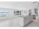 Bright living room with waterfront views, kitchen island, and modern decor at 326 176Th Avenue Cir, Redington Shores, FL 33708