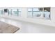 Bright living room featuring water views from large windows, with access to dock and boat lift at 326 176Th Avenue Cir, Redington Shores, FL 33708