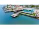 Exterior rear view of waterfront property including a dock, tiki bar, and pool at 326 176Th Avenue Cir, Redington Shores, FL 33708