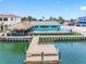 Waterfront home features a dock, pool, tiki bar, and ample deck space at 326 176Th Avenue Cir, Redington Shores, FL 33708