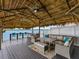 Outdoor living with a full kitchen, bar, and spacious seating area at 326 176Th Avenue Cir, Redington Shores, FL 33708