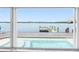 Enjoy gorgeous views through the sliding glass door, overlooking the pool, dock, and bay at 326 176Th Avenue Cir, Redington Shores, FL 33708