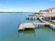 Serene waterfront setting with a private dock, a tiki bar, and lovely views of the water at 326 176Th Avenue Cir, Redington Shores, FL 33708