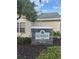 Stone sign for the community clubhouse, with manicured landscaping around the base at 3260 Haviland Ct # 202, Palm Harbor, FL 34684