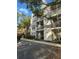 Condo building featuring balconies and outdoor living, lush landscaping and ample parking at 3260 Haviland Ct # 202, Palm Harbor, FL 34684