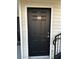 Black front door with gold number 202, trimmed in white at 3260 Haviland Ct # 202, Palm Harbor, FL 34684