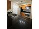 Well-lit kitchen featuring black granite countertops, stainless steel appliances, and wood cabinets at 3260 Haviland Ct # 202, Palm Harbor, FL 34684