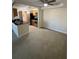 Open-concept living space with neutral carpet flooring connected to the kitchen at 3260 Haviland Ct # 202, Palm Harbor, FL 34684