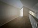 Wide angle view of the carpeted loft space at 3260 Haviland Ct # 202, Palm Harbor, FL 34684