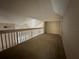 Carpeted loft space features railing and view from above at 3260 Haviland Ct # 202, Palm Harbor, FL 34684