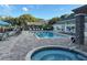 Community pool area with a spa and ample seating for residents and guests at 3260 Haviland Ct # 202, Palm Harbor, FL 34684