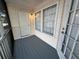 Screened porch features door, window, and painted wood floor at 3260 Haviland Ct # 202, Palm Harbor, FL 34684