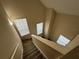 View looking down carpeted stairway with three windows at 3260 Haviland Ct # 202, Palm Harbor, FL 34684