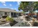 Relaxing back patio features pavers, room for outdoor seating, and a lovely landscaped yard at 3417 W Alline Ave, Tampa, FL 33611