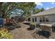 Spacious backyard with wood fence, outdoor seating, screened-in patio, and landscaping at 3417 W Alline Ave, Tampa, FL 33611