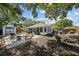 Expansive backyard with a patio, shed, playset, outdoor seating, landscaping, and wood fence at 3417 W Alline Ave, Tampa, FL 33611