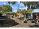Large backyard with a wood fence, seating area, metal planters, and a fire pit at 3417 W Alline Ave, Tampa, FL 33611