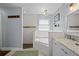 Well-lit bathroom showcasing a soaking tub with a shower and a vanity with marble countertop at 3417 W Alline Ave, Tampa, FL 33611