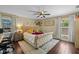 Comfortable bedroom with hardwood floors, neutral colors, a ceiling fan, and bright windows at 3417 W Alline Ave, Tampa, FL 33611