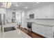 Bright kitchen features white cabinets, stainless steel appliances, and hardwood flooring at 3417 W Alline Ave, Tampa, FL 33611