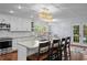 Modern kitchen featuring an island with barstool seating, stainless appliances, and pendant lighting at 3417 W Alline Ave, Tampa, FL 33611