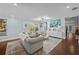 Bright living room with wood floors, comfortable seating, and a view into the dining area at 3417 W Alline Ave, Tampa, FL 33611