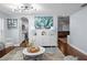 Open living room with a view into a kitchen, modern lighting, and hardwood floors at 3417 W Alline Ave, Tampa, FL 33611