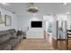 Cozy living room with hardwood floors, a ceiling fan, and a comfortable gray couch at 3417 W Alline Ave, Tampa, FL 33611