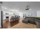 Open-concept living room and kitchen space with hardwood floors and neutral colors at 3417 W Alline Ave, Tampa, FL 33611