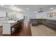 Open-concept living space with a breakfast bar and a comfortable seating area with views to the backyard at 3417 W Alline Ave, Tampa, FL 33611