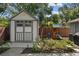 Well-maintained storage shed adjacent to an outdoor playset with a slide and swings at 3417 W Alline Ave, Tampa, FL 33611